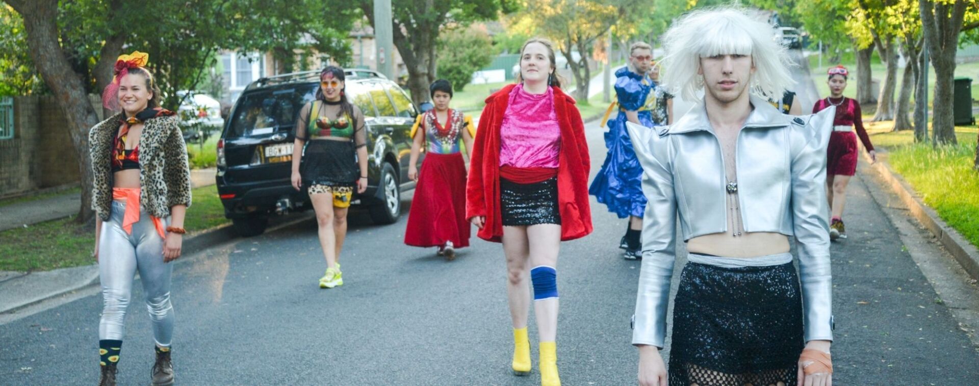 WE ARE HERE Company dancers walking down a suburban street